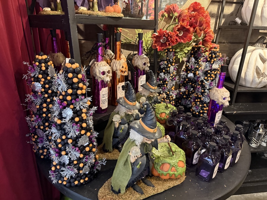 Witch figurines, potion bottles, and festive decor